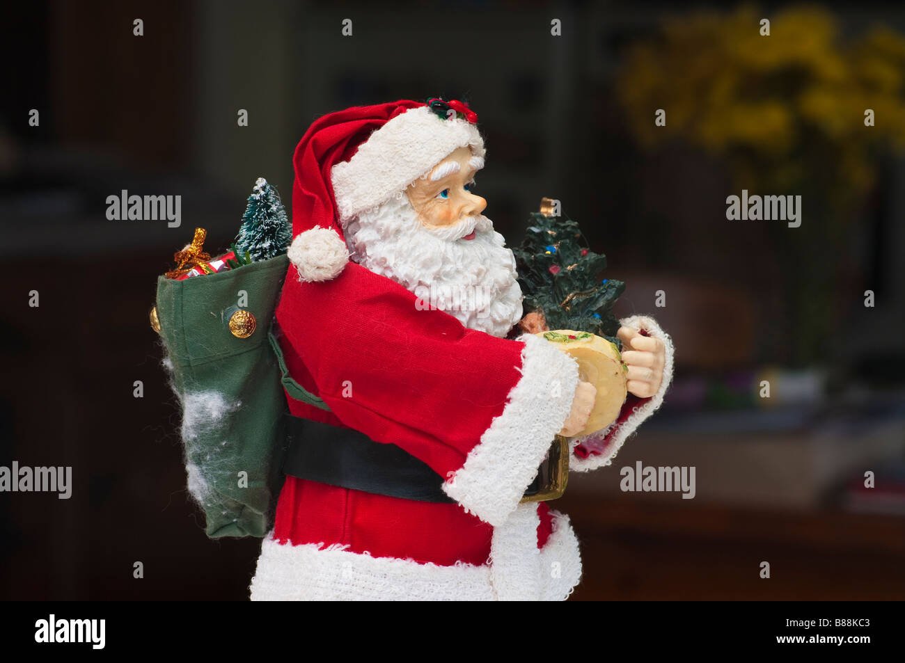 Toy Father Christmas with sack of toys on his back Stock Photo