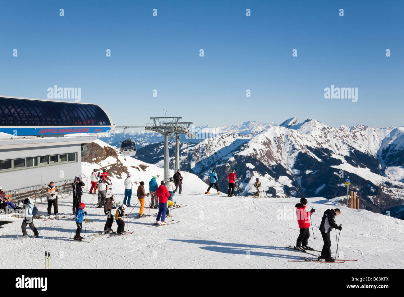Rauris Austria. Skiers outside Gipfelbahn summit gondola station at top of Rauriser Hochalmbahnen ski runs in alps in winter Stock Photo