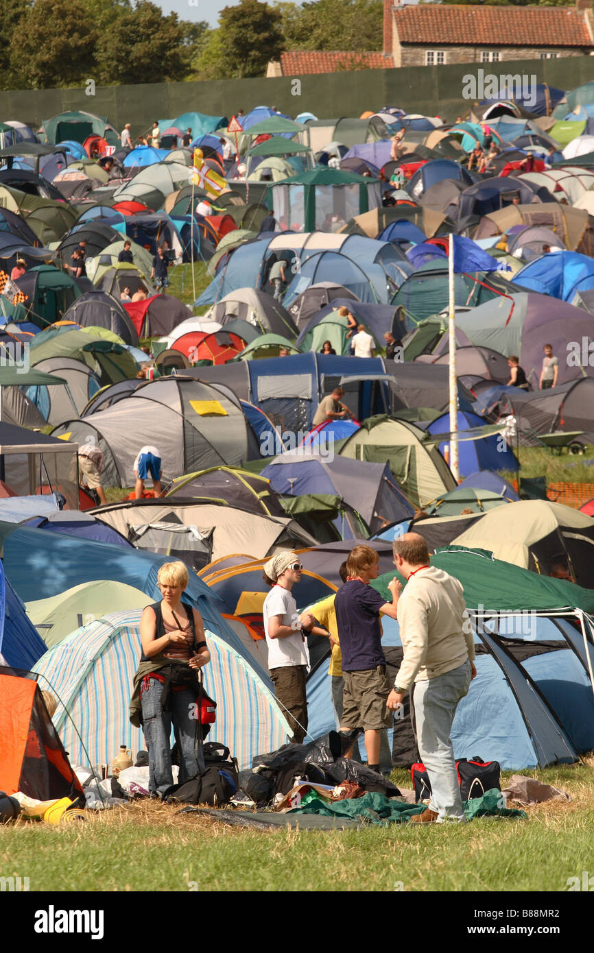 Glastonbury Festival fans and festival goers putting up tents in busy hectic tent camping area scene at Glastonbury June 2008 Stock Photo