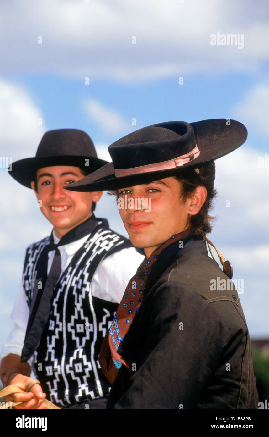 Young gauchos on horseback with hats in Argentina Stock Photo