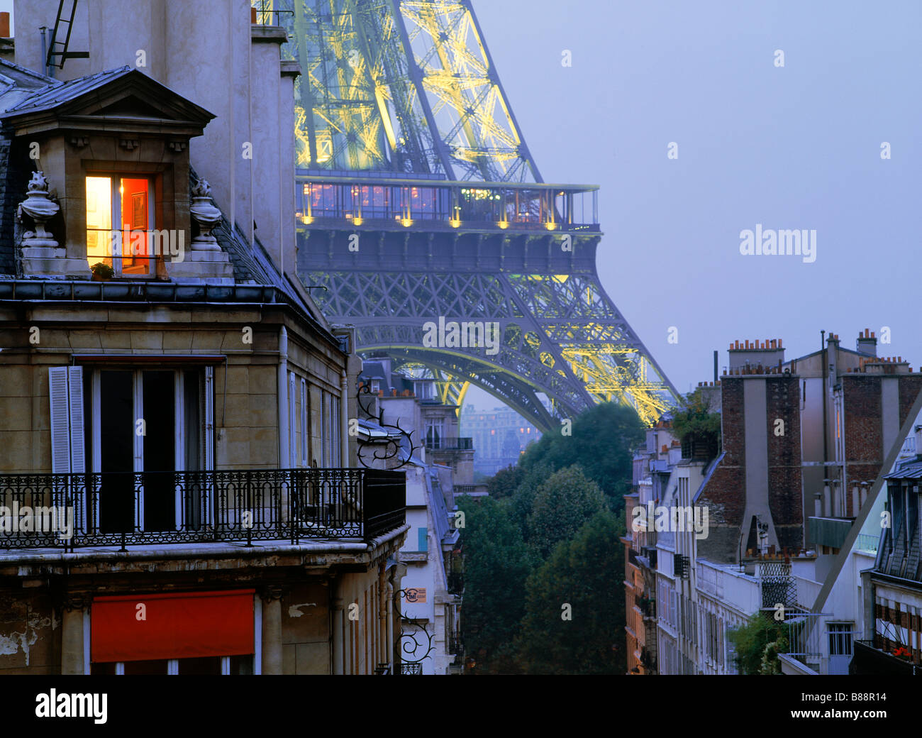 Light in top floor apartment window with Eiffel Tower depicting Paris night  life Stock Photo - Alamy