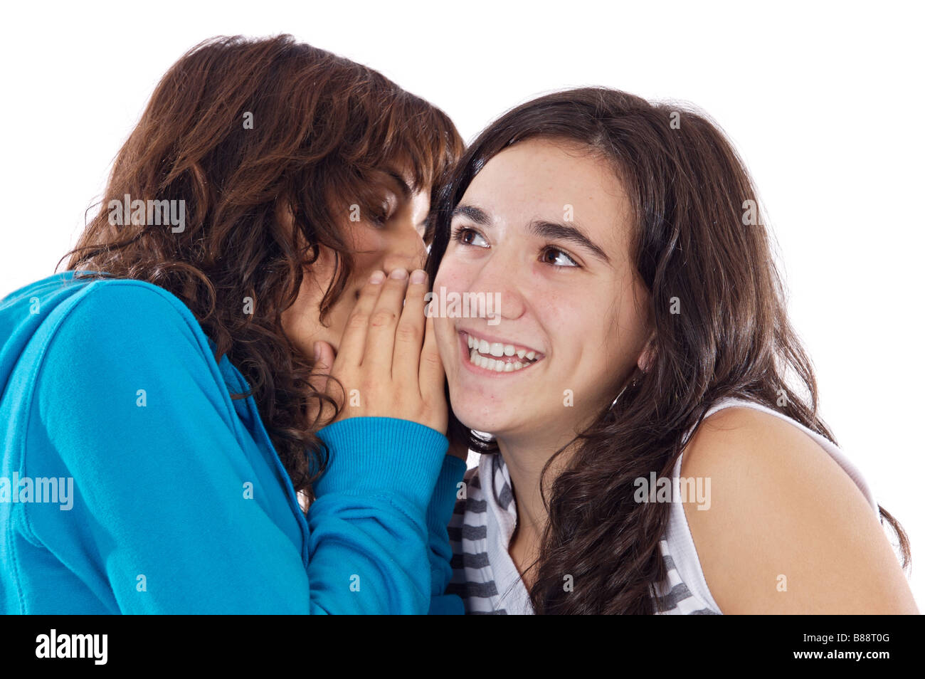 Two teenager girls whispering a secret to the ear Stock Photo - Alamy