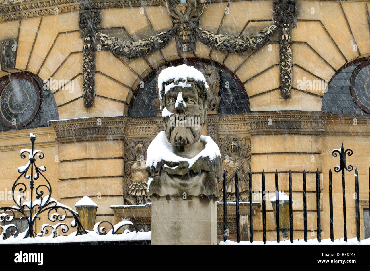 The emperor figures round the Sheldonian Theatre Oxford University in snow Stock Photo