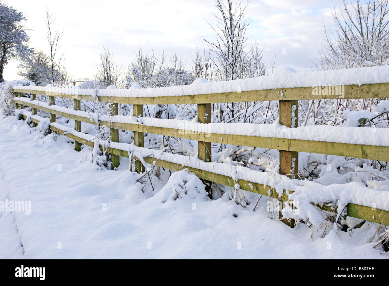 A snow covered ranch fence Stock Photo