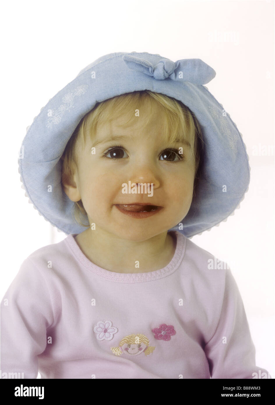 Toddler wearing a blue sun hat Stock Photo Alamy