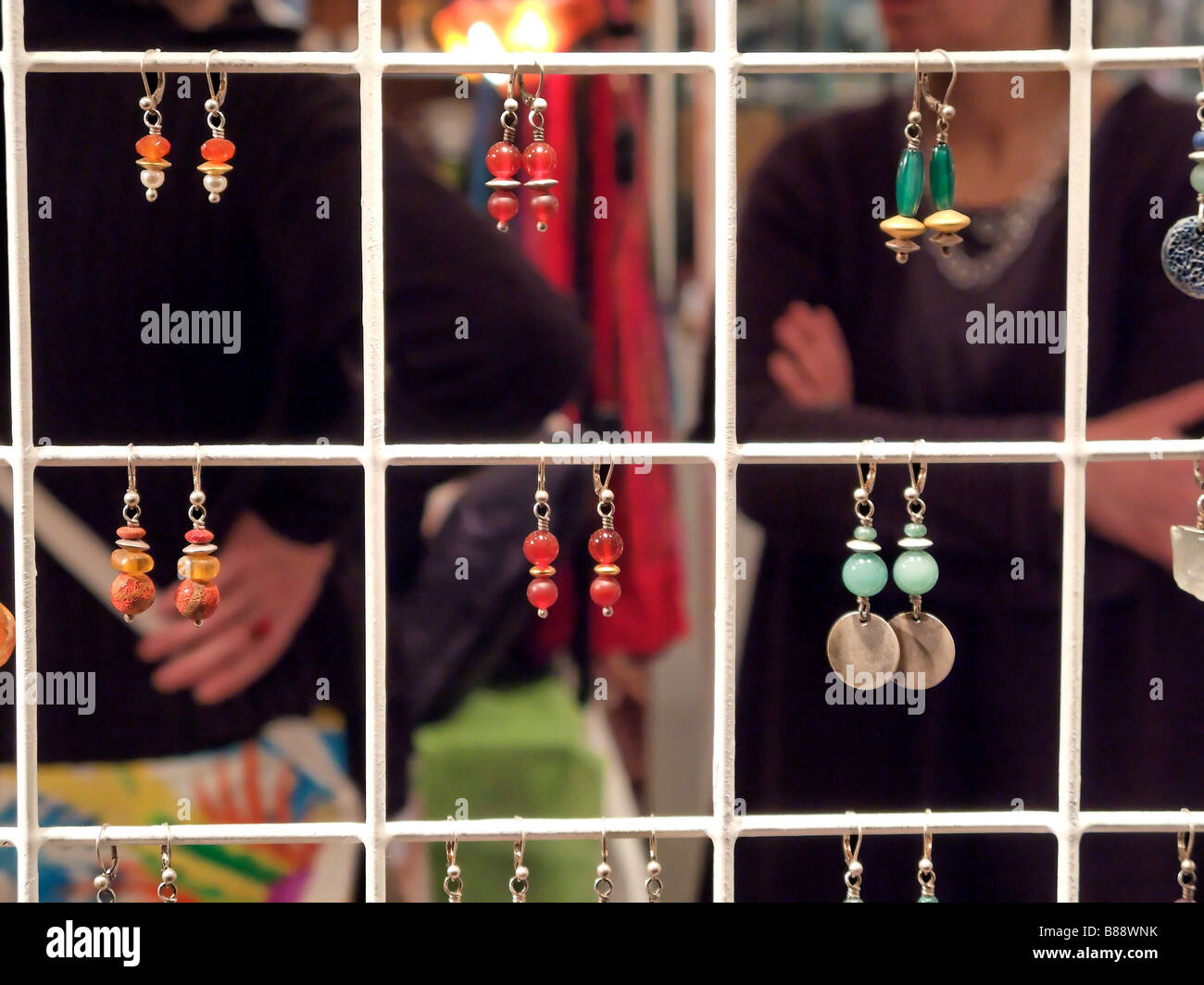 Display of Womans Fashion Earings Hanging from a White Metal Square Frame Stock Photo