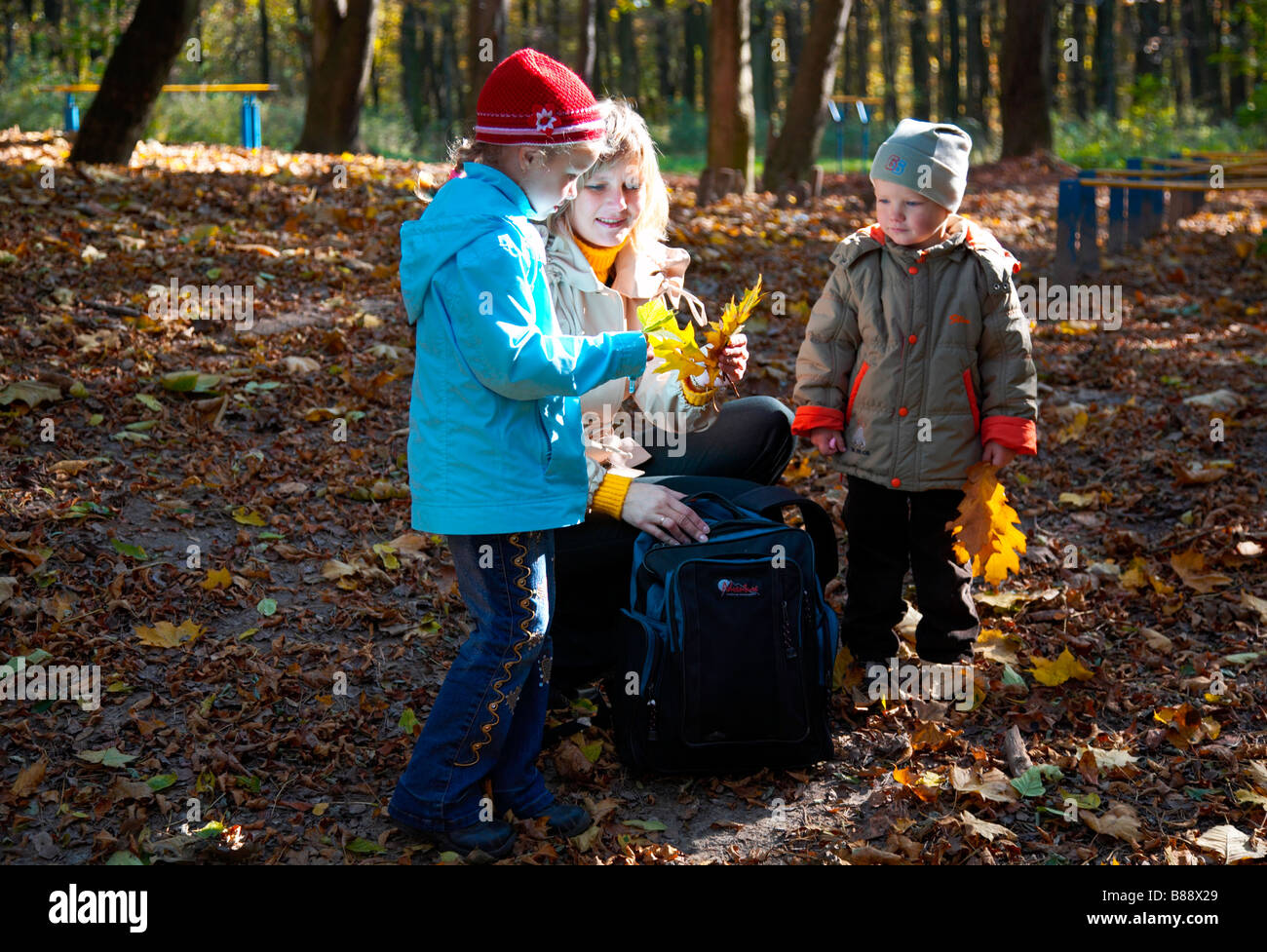 Happy family (mother with children) in golden autumn city park Stock ...