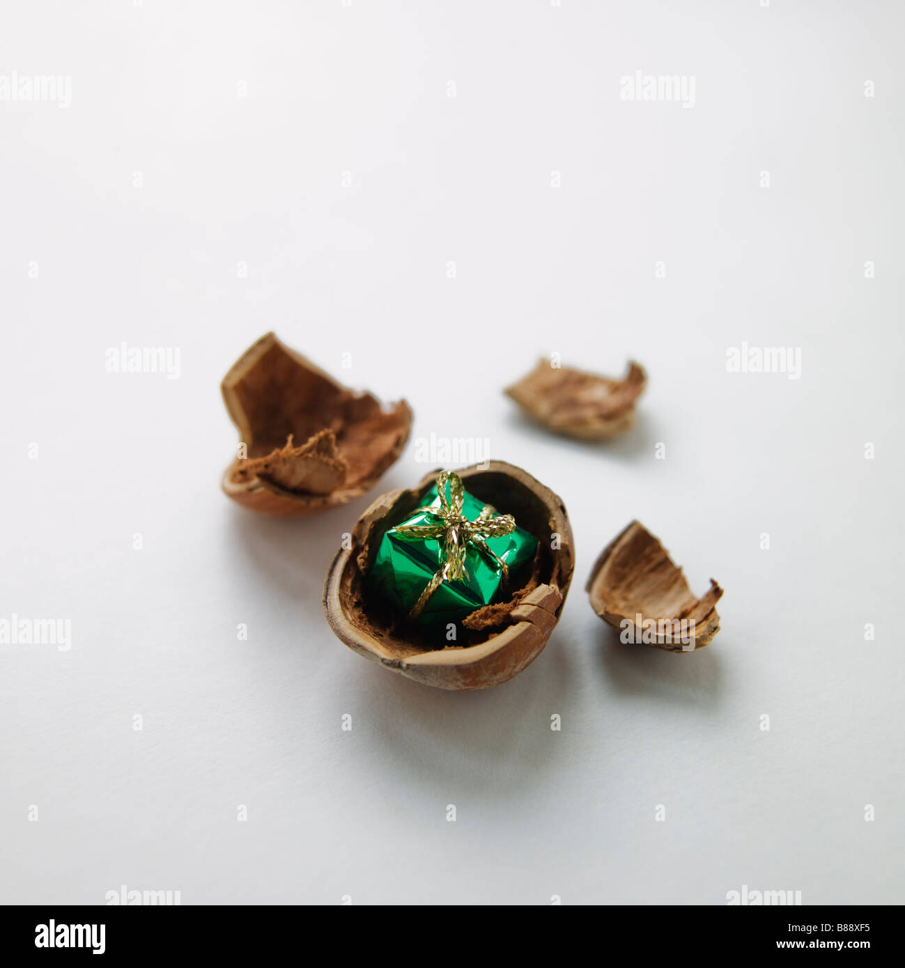 open hazelnut with festive present inside Stock Photo