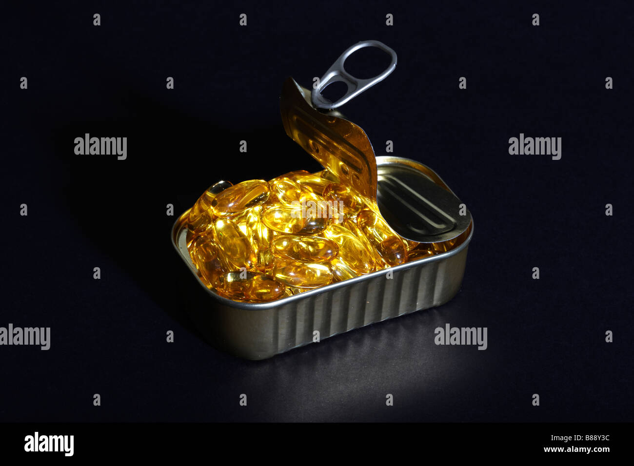 Fish Oil Capsules in an open Sardine Can Stock Photo Alamy