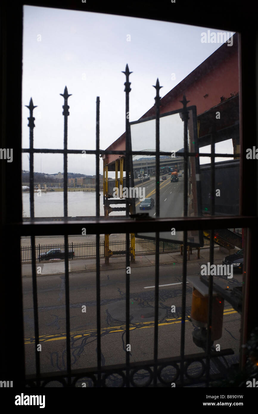View of highway through window covered by ornate iron bars Stock Photo