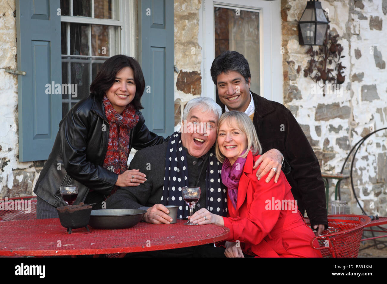 four friends having drinks outdoors winter spring fall Stock Photo - Alamy