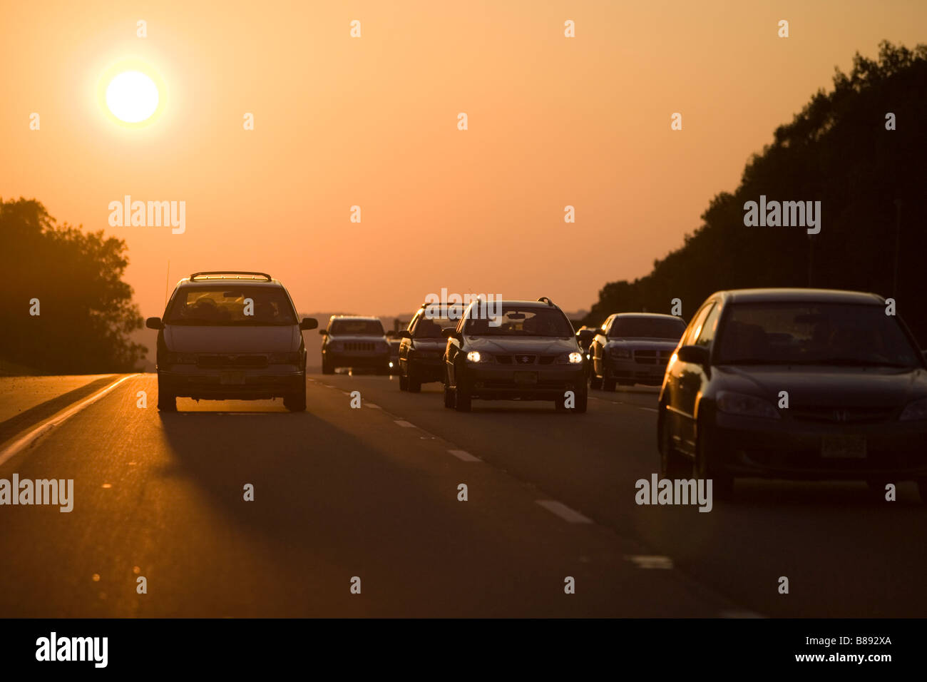 Sunset over a major highway with cars and trucks Stock Photo - Alamy
