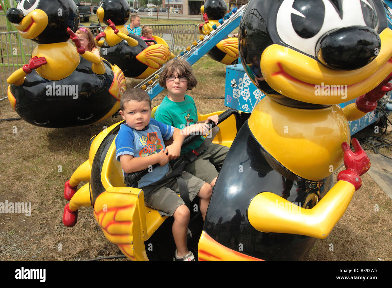 Two kids on an amusement ride at the county fair Stock Photo