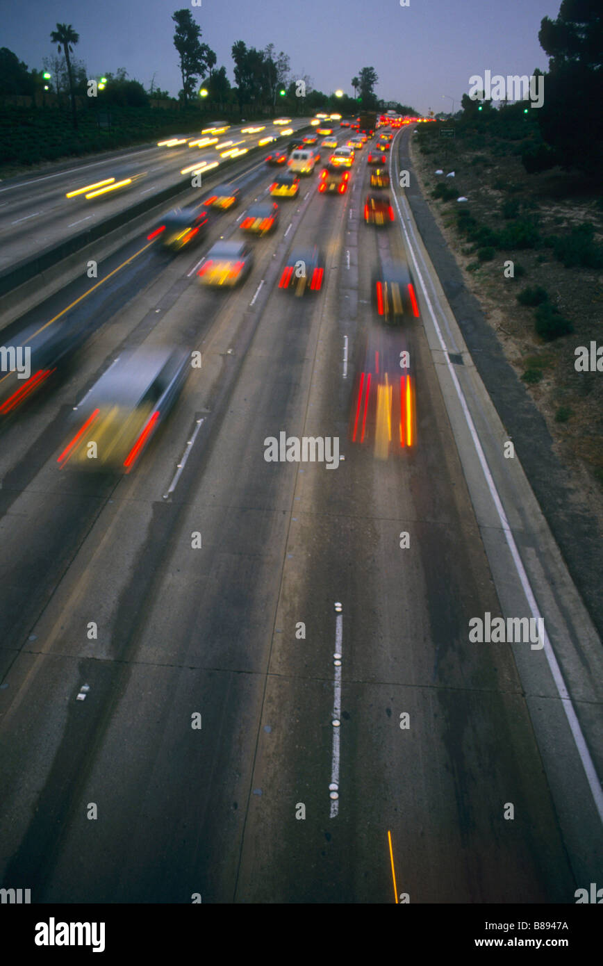 Cars blur as they speed along California freeway oil economy transport Stock Photo