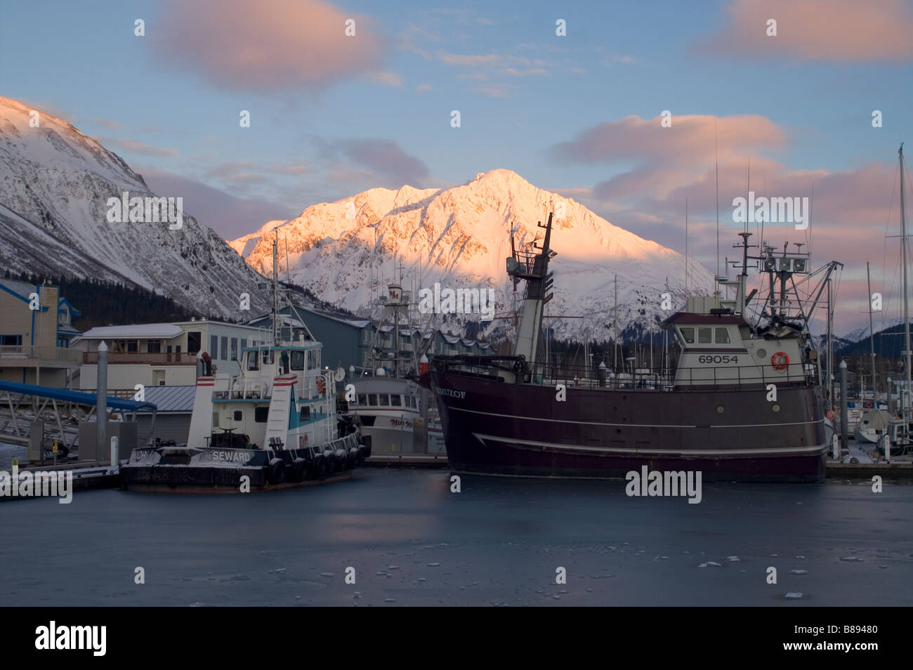 Seward Alaska and Fishing Boats Resurrection Bay Waterfront dock marina water Mountains United States North America Stock Photo