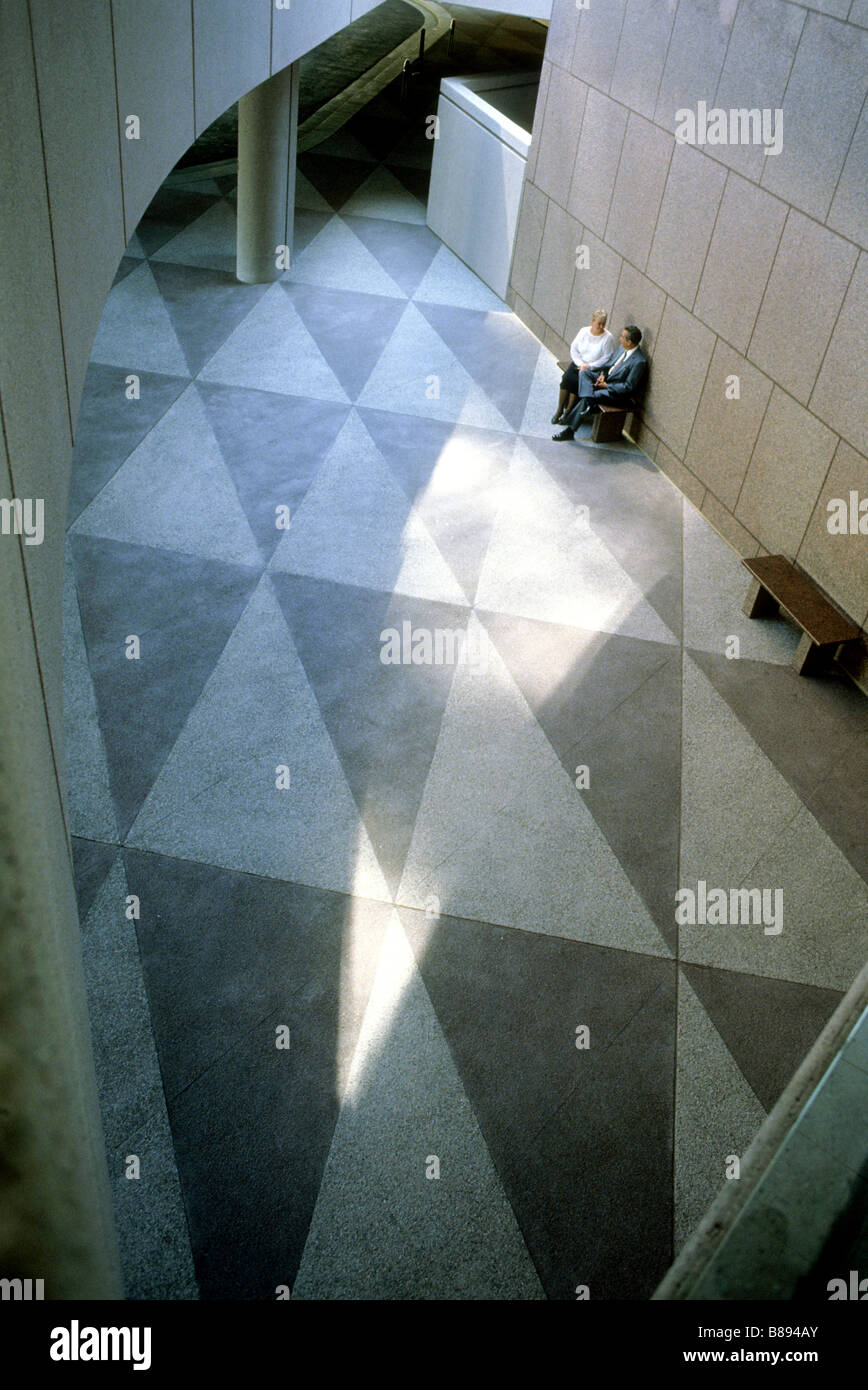 Couple walks across terrazzo floor featuring triangles at Orange County