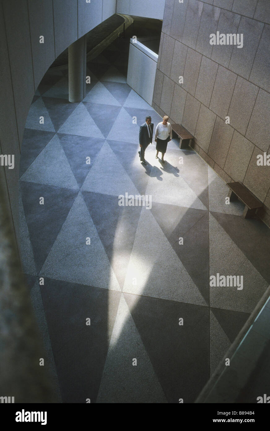 Couple walks across terrazzo floor featuring triangles at Orange County
