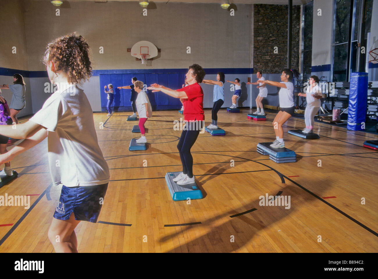 People exercise in aerobics class at YMCA gym California Stock Photo