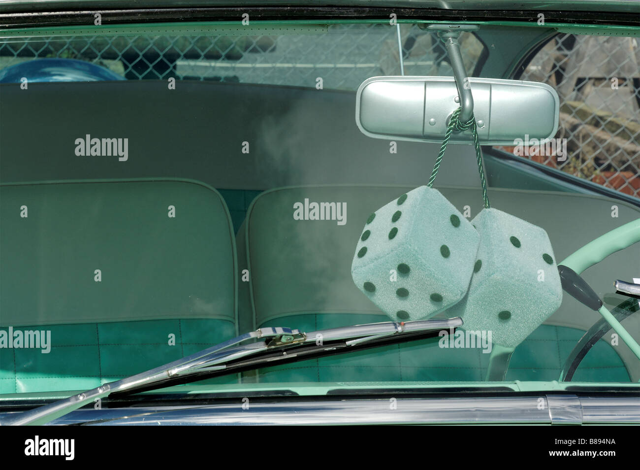 Furry dice in the window of a vintage Ford Fairlane 500 Stock Photo