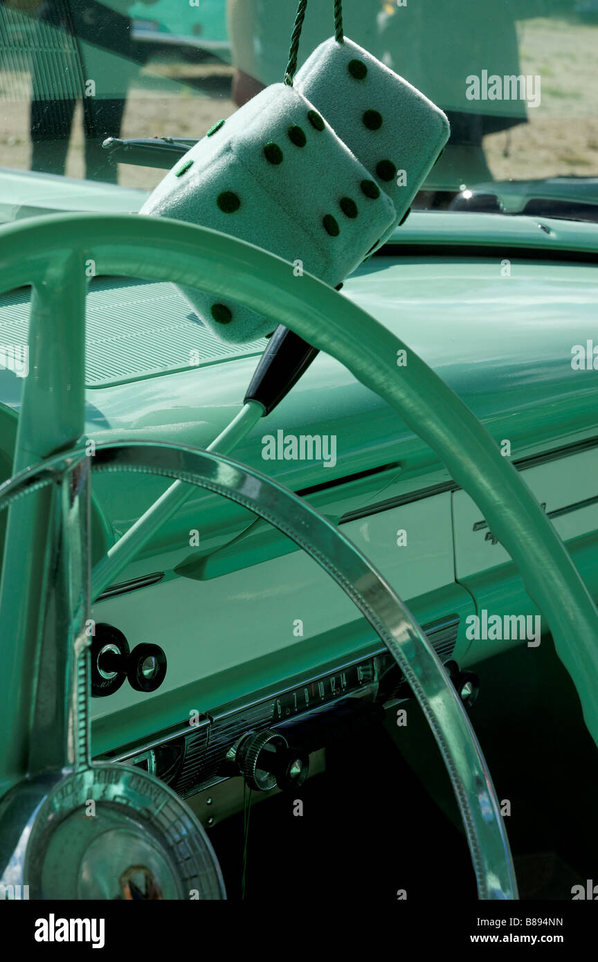 Furry dice in the window of a vintage Ford Fairlane 500 Stock Photo