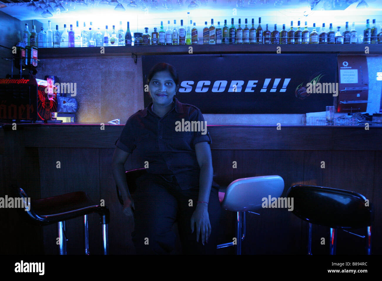 A female bouncer sits in a bar at the where she is working in