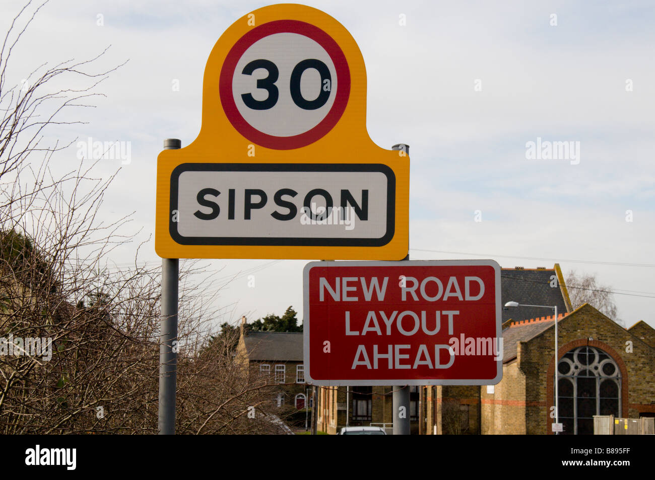 A 'No Third Runway' protest sign and 'New Road Layout' sign on the edge of Sipson, site of Heathrow's proposed third runway. Stock Photo