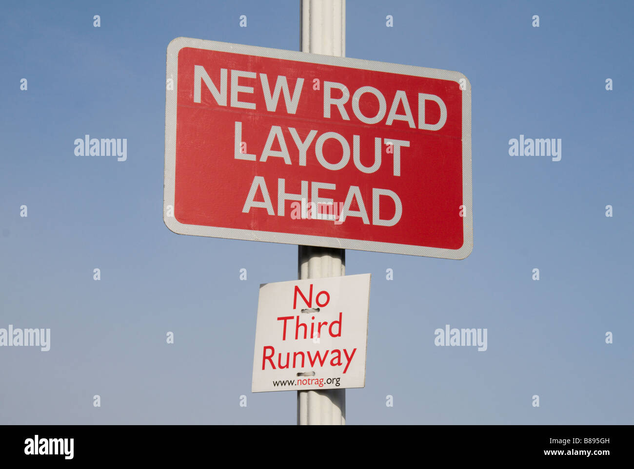 A 'No Third Runway' protest sign and a 'New Road Layout' sign on the edge of Sipson, site of Heathrow's proposed third runway. Stock Photo