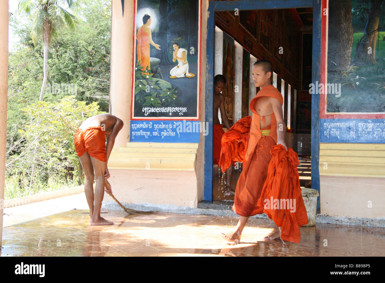 Portrait of Buddhist monks cleaning a temple taken by Lolei temple in Cambodia near Angkor Wat. Stock Photo