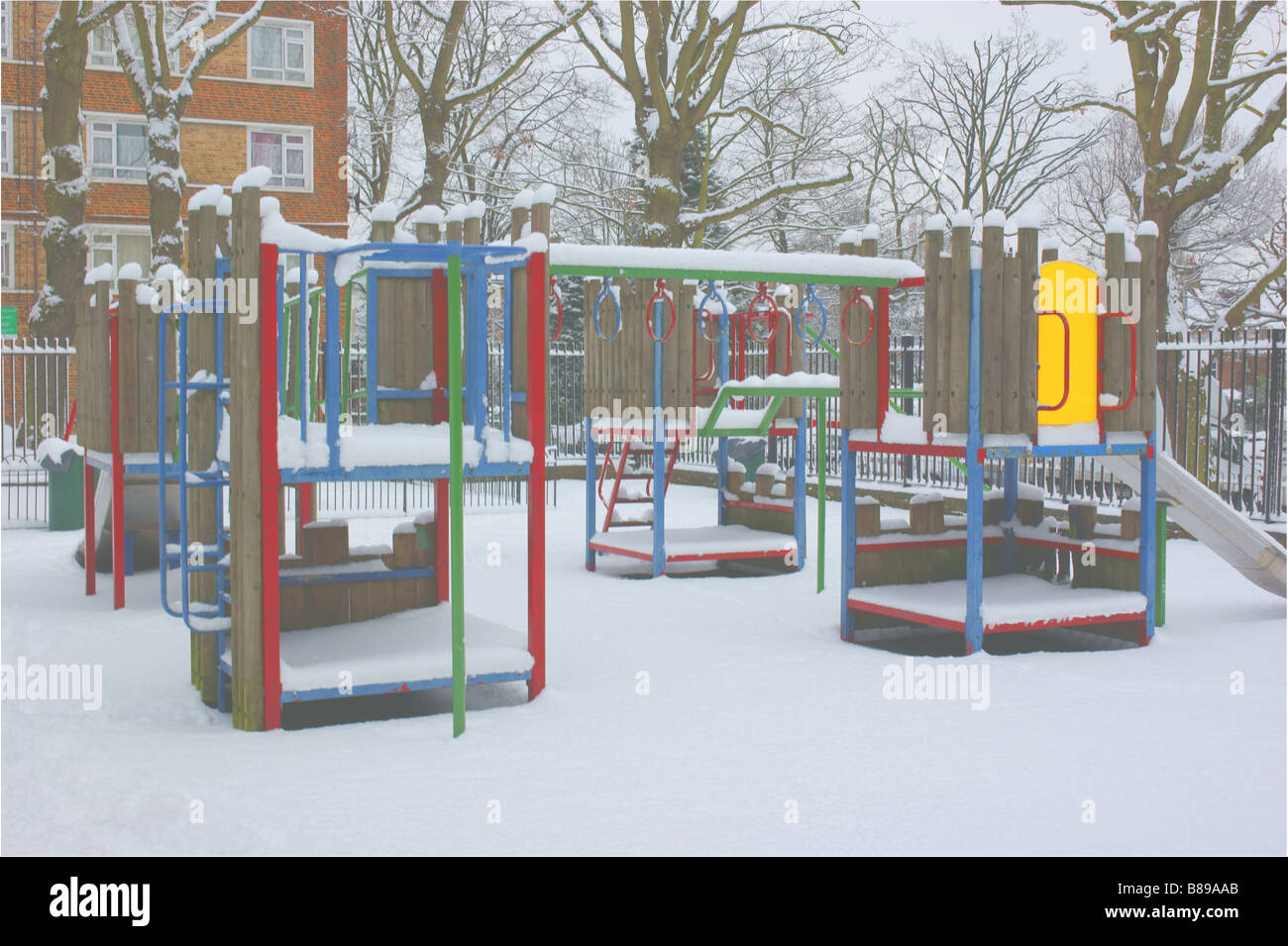 North London estate playground / playground climbing frame  covered in untouched snow after heaviest snowfall in years. Stock Photo