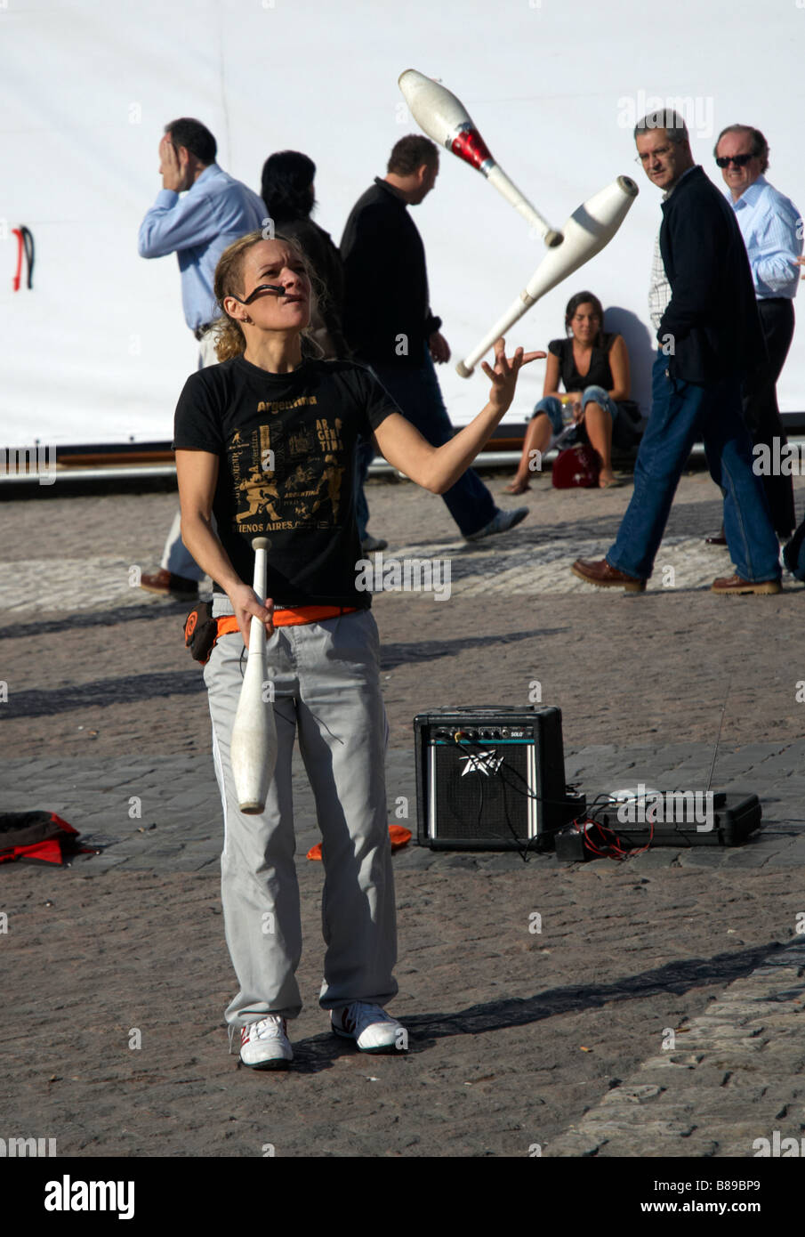 A young woman juggles for passers-by on Plaza Mayor, Madrid, Spain Stock Photo