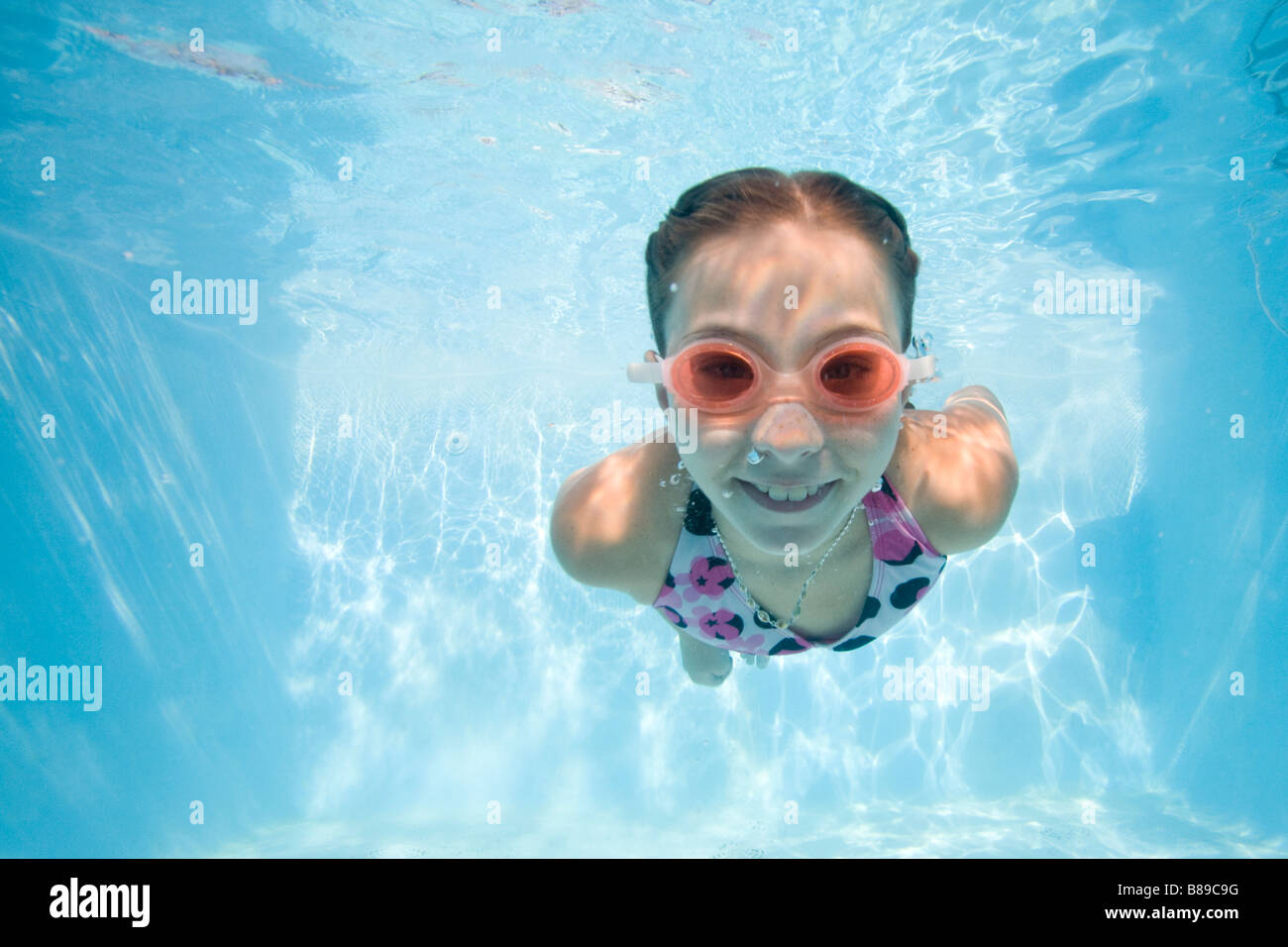 girl swimming underwater Stock Photo