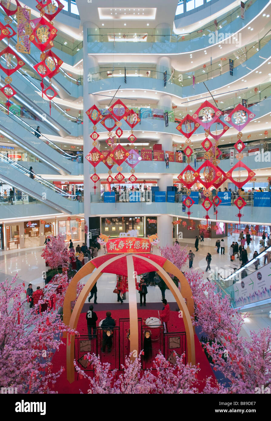 Interior atrium of modern APM shopping mall on Wangfujing street in central Beijing 2009 Stock Photo