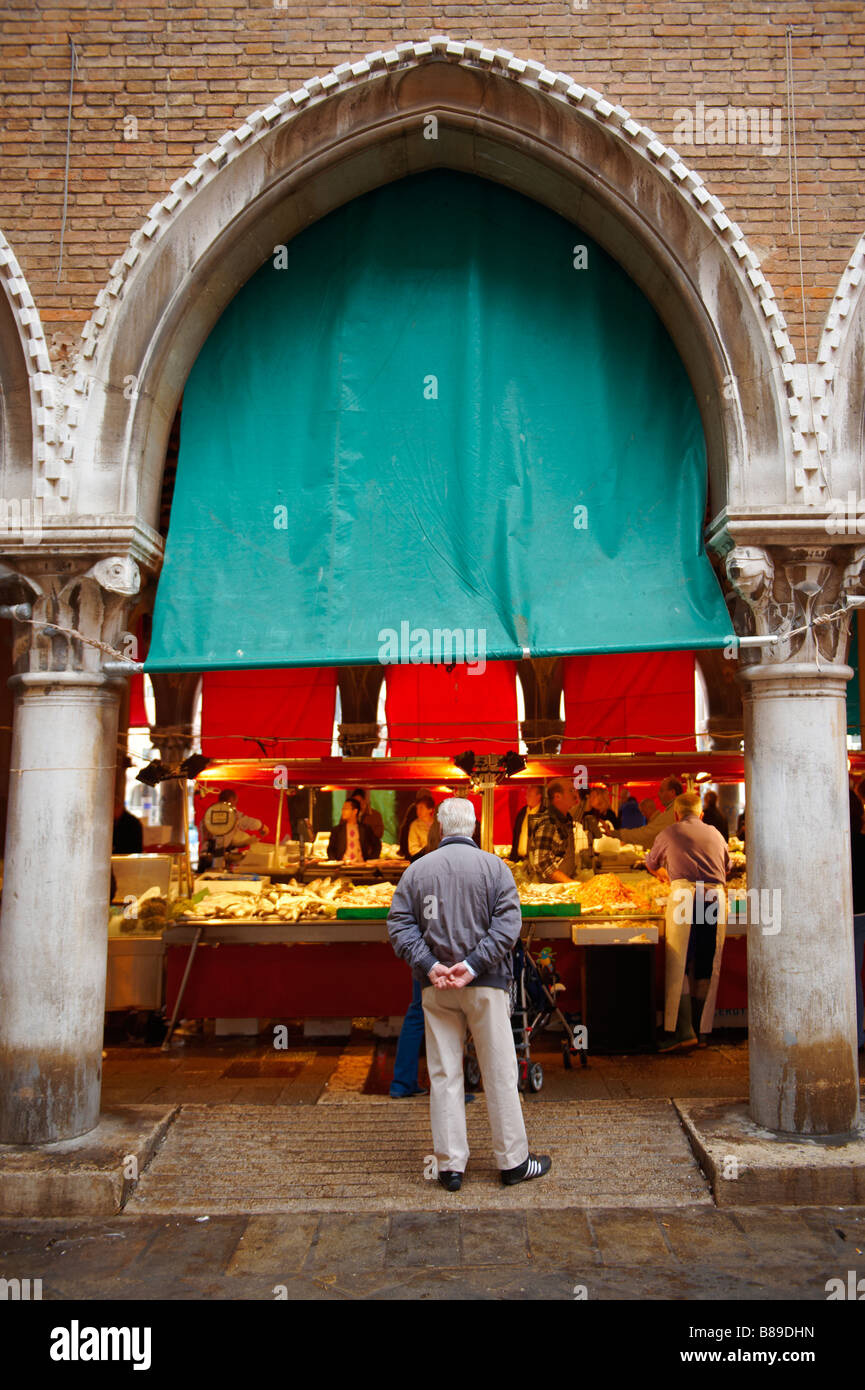 Venetians buying fresh fish in the Rialto market, Venice Stock Photo
