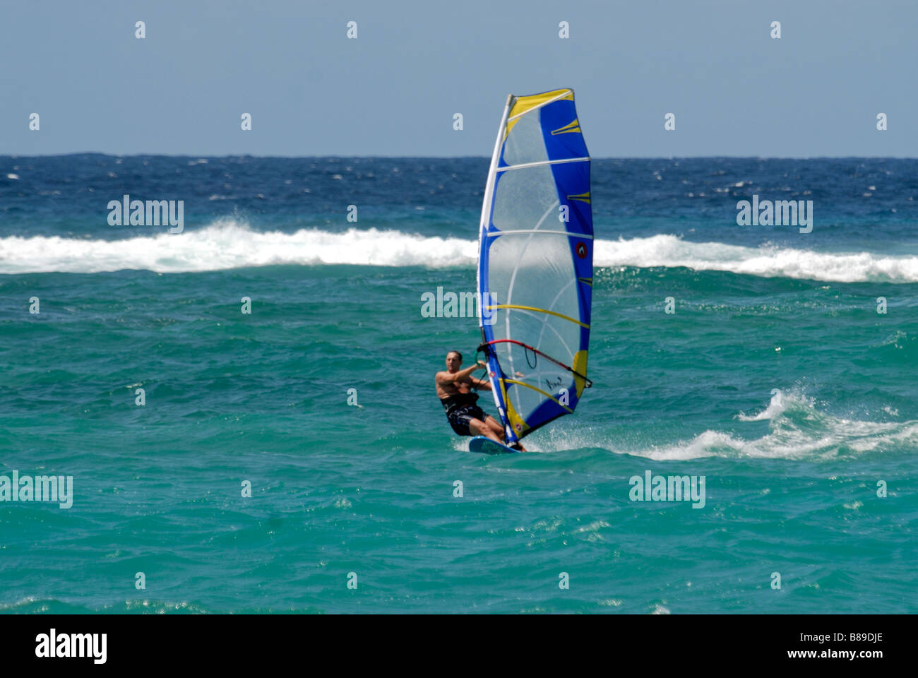 A surfer at silver sand beach Barbados Caribbean Stock Photo