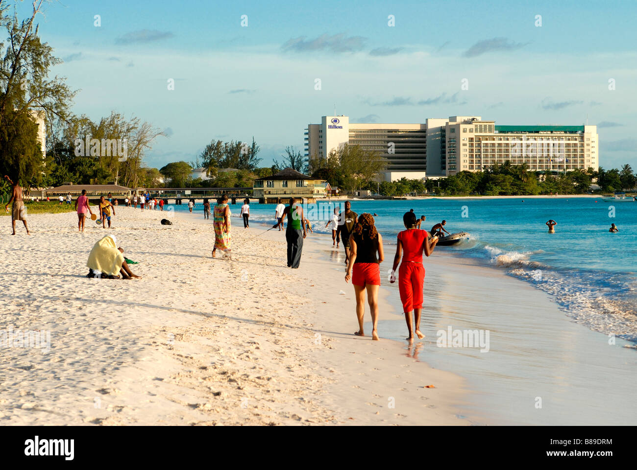 Carlisle bay beach at Barbados with some people walking along it Caribbean Stock Photo