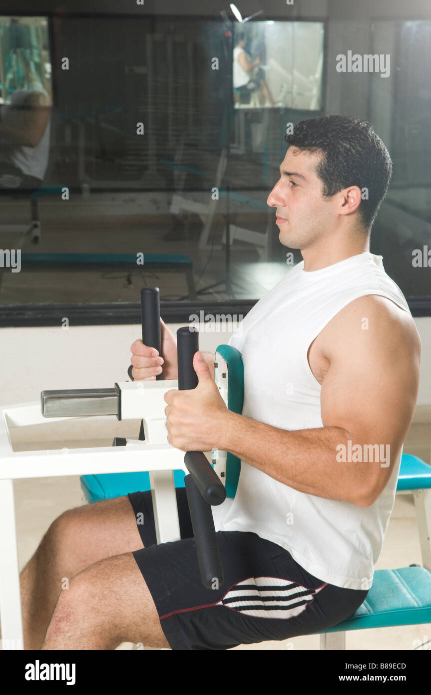 Man exercising on the lats machine in the gym Stock Photo