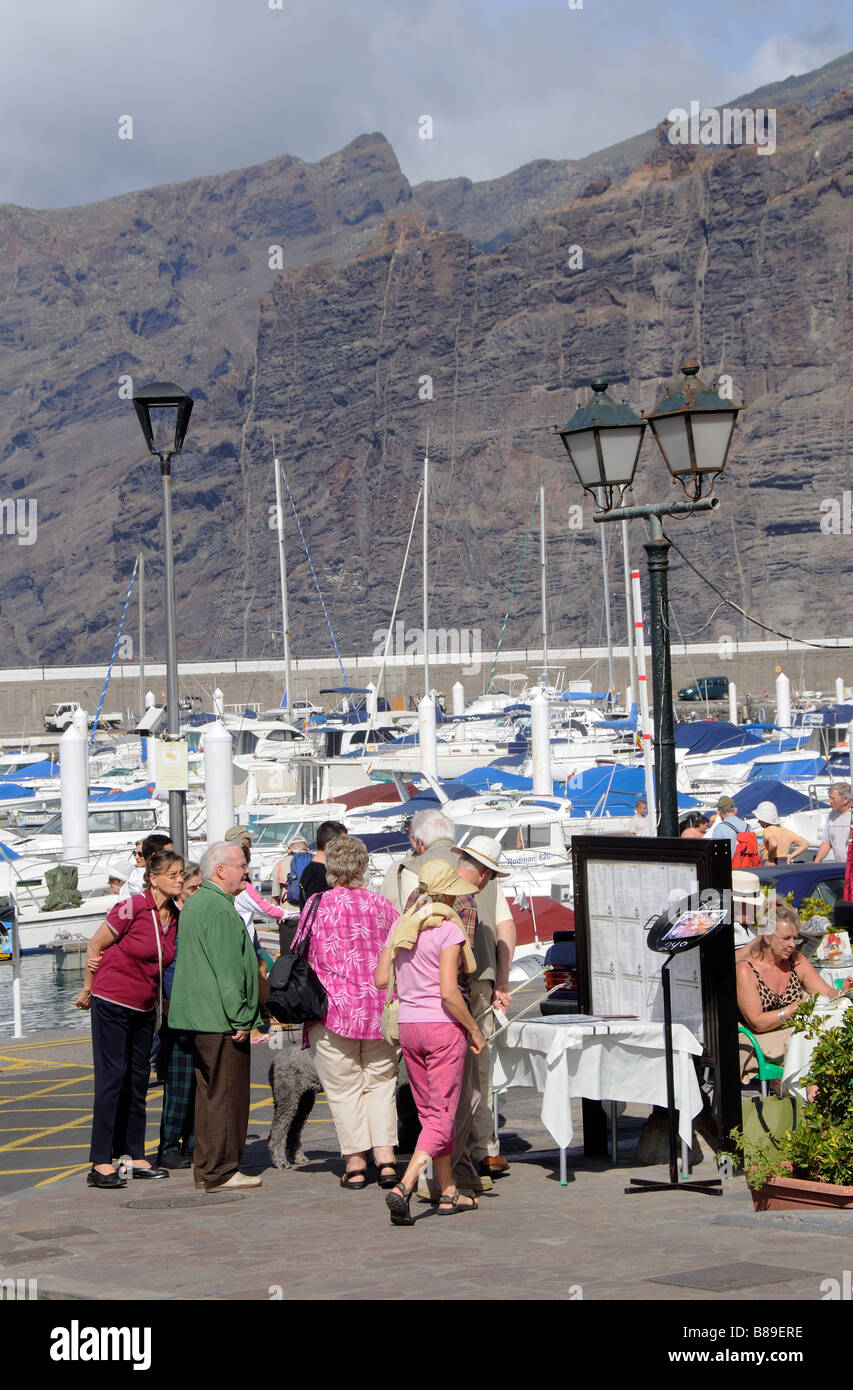 Potential customers reading a restaurants menu board in the port area