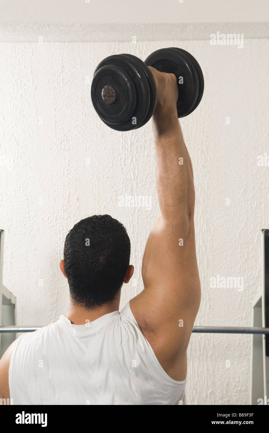 Man lifting free weight dumbbell in the gym Stock Photo Alamy