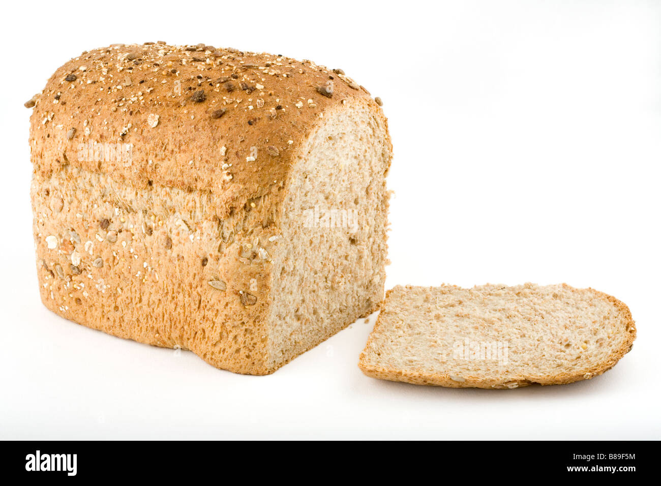 A loaf of wholemeal multigrain bread and slice Stock Photo