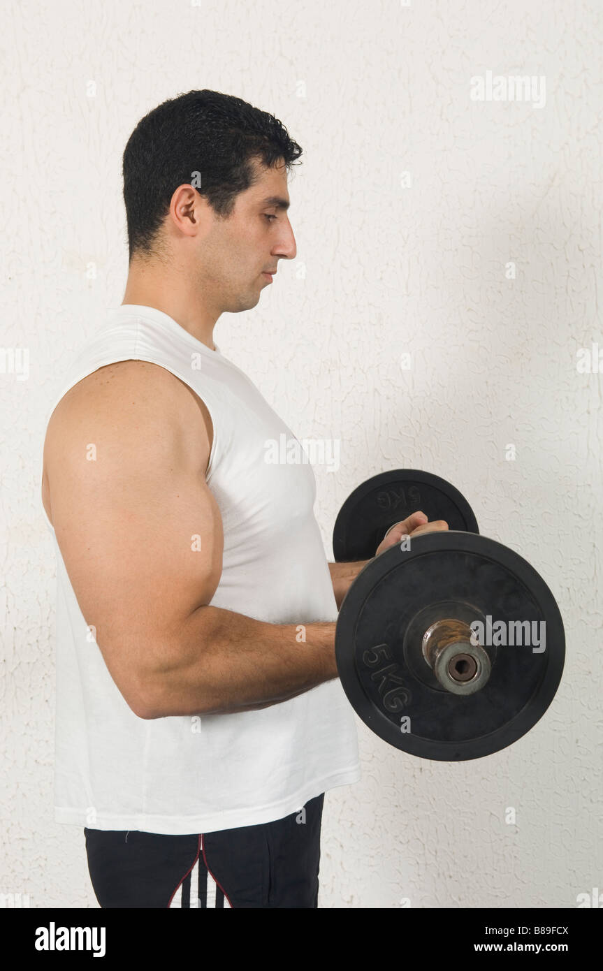 Man training biceps curls in the gym Stock Photo Alamy