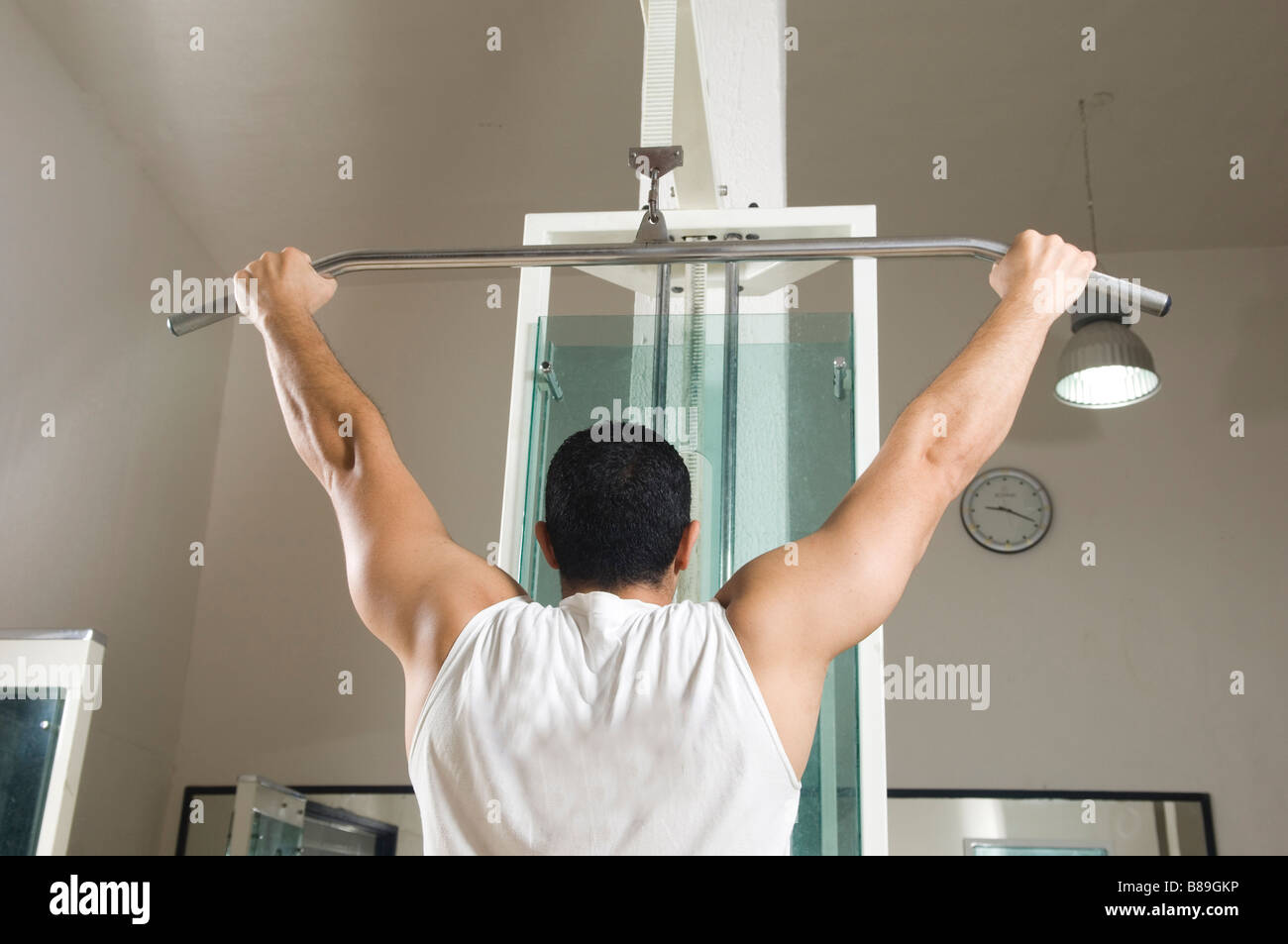 Man doing lat pulldown exercise in the gym Stock Photo