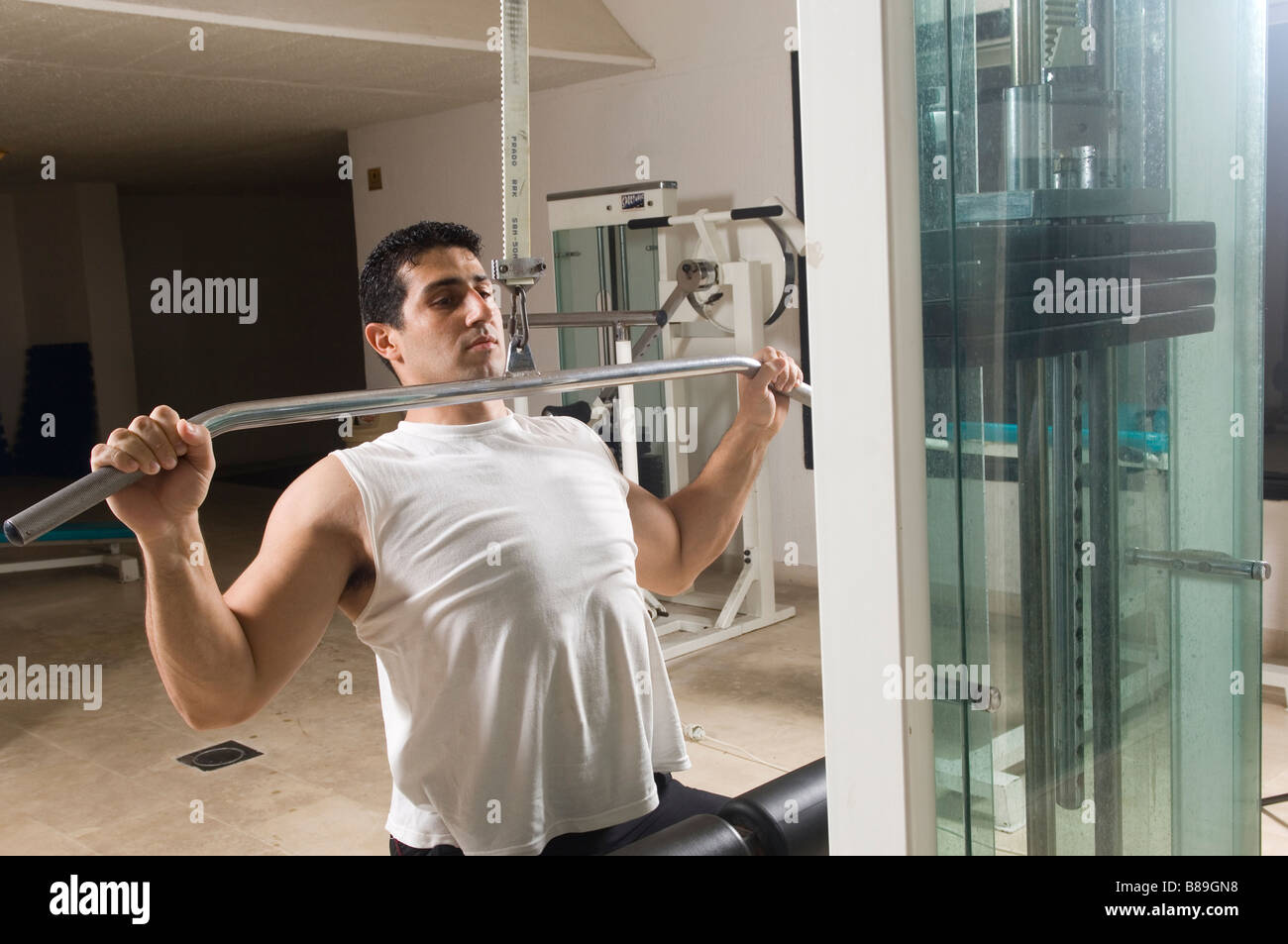 Man doing lat pulldown exercise in the gym Stock Photo