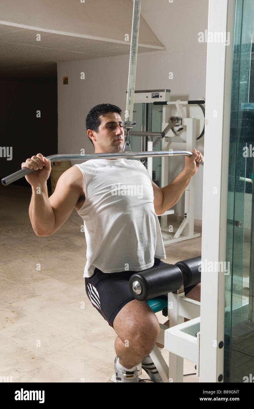 Man doing lat pulldown exercise in the gym Stock Photo