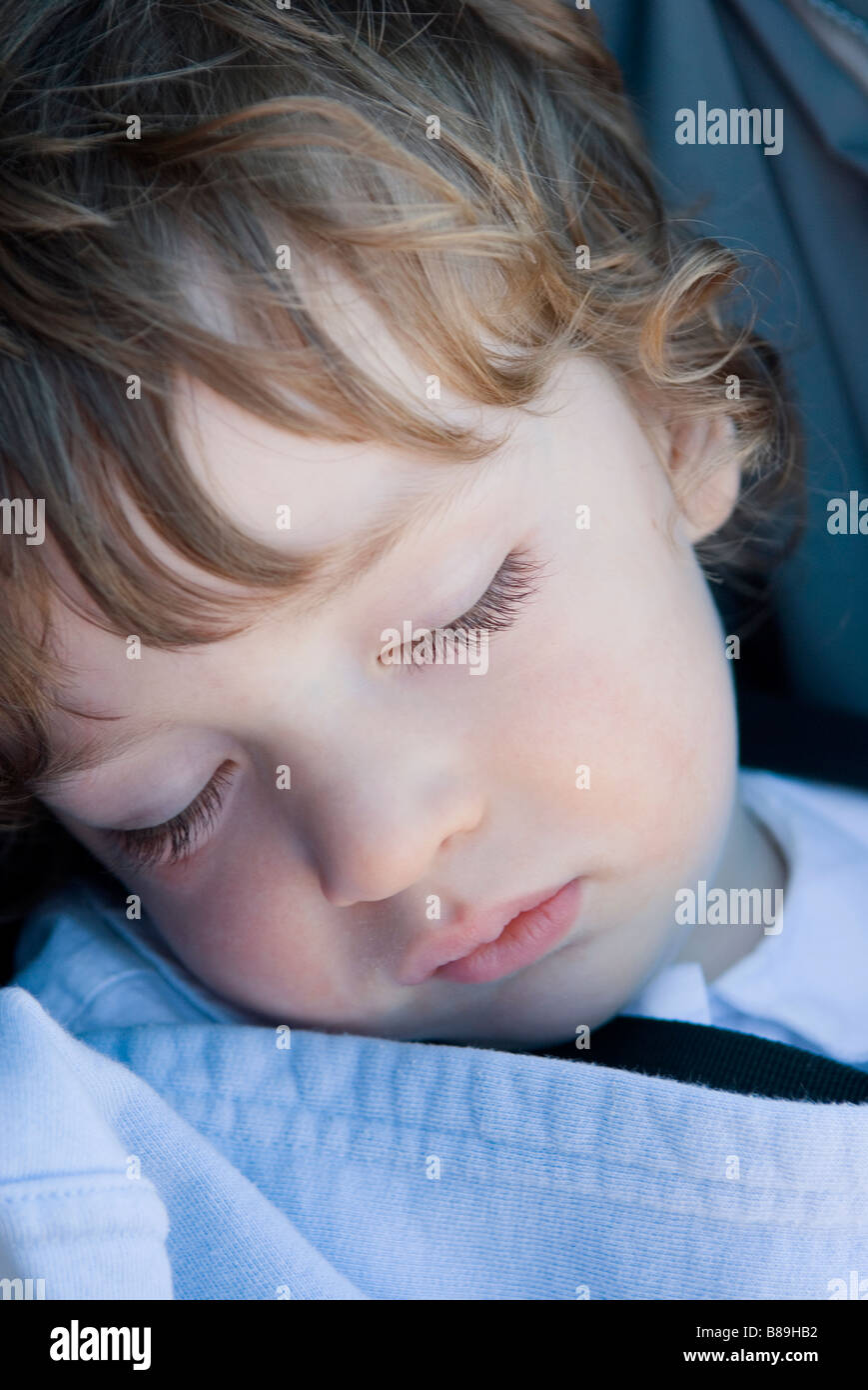 A young boy sleeps in his carseat Stock Photo Alamy
