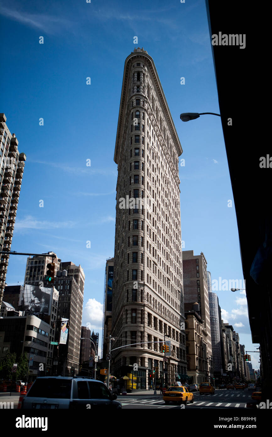 the flatiron building located at the intersection of fifth avenue and