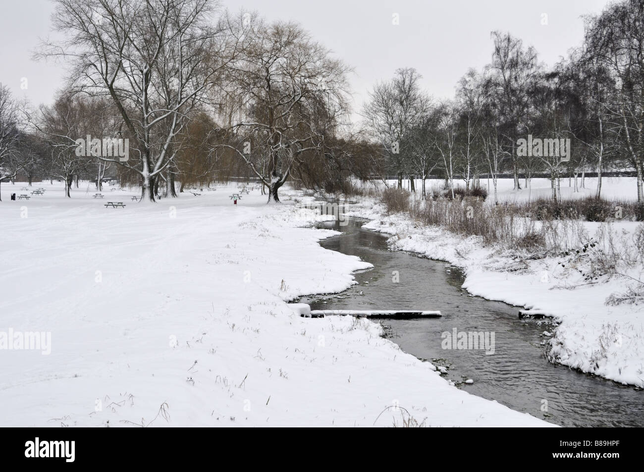 Gade River in snow covered Gadebridge Park Hemel Hempstead UK Stock