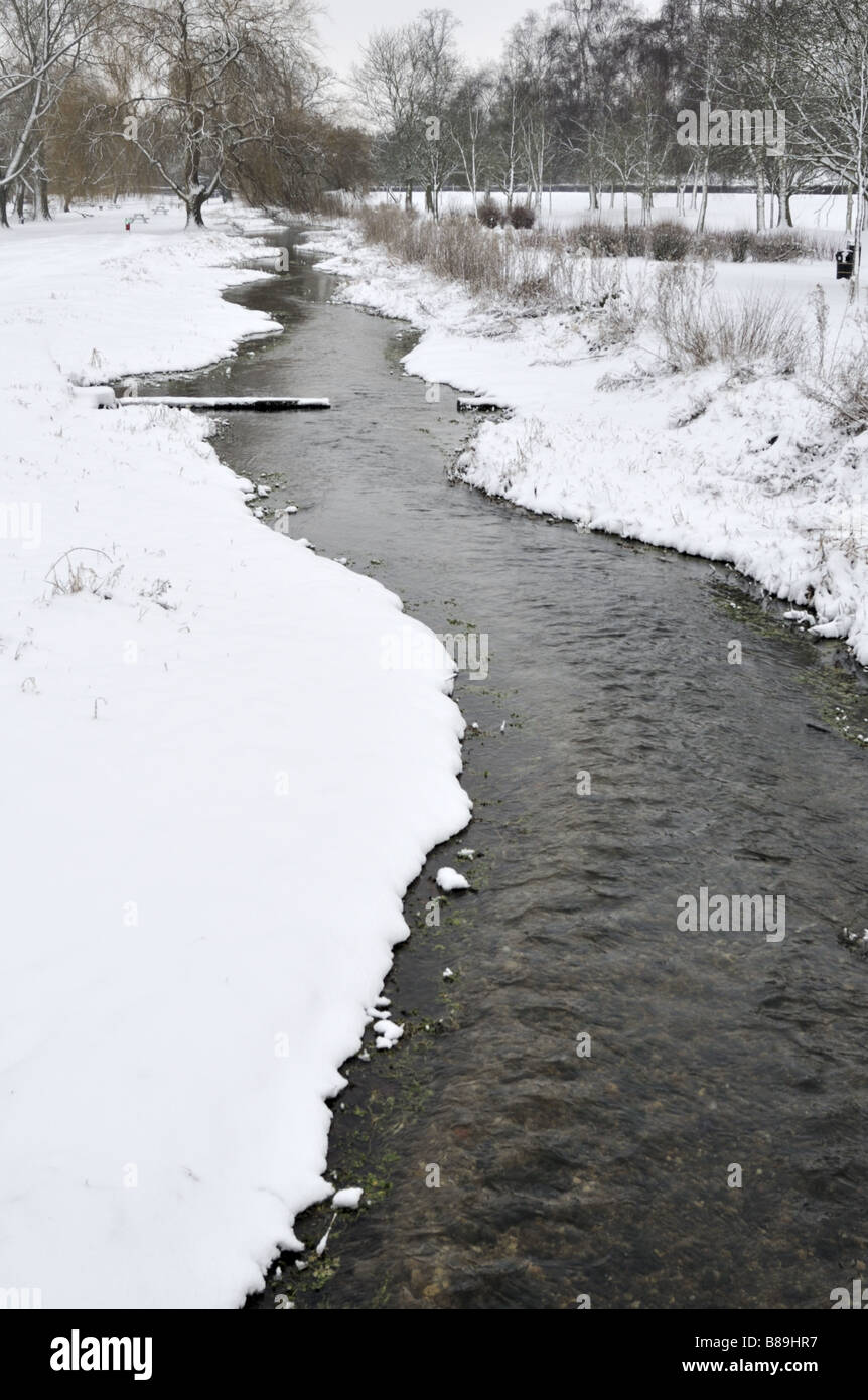 Gade River in snow covered Gadebridge Park Hemel Hempstead UK Stock