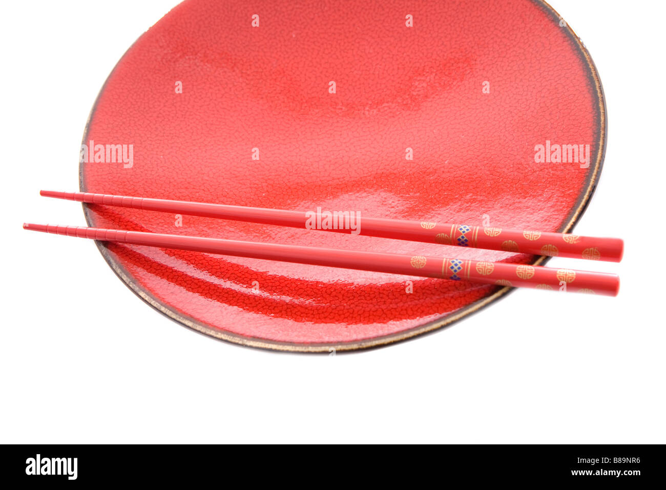 Red dish and chopsticks with oriental style on a white background Stock Photo