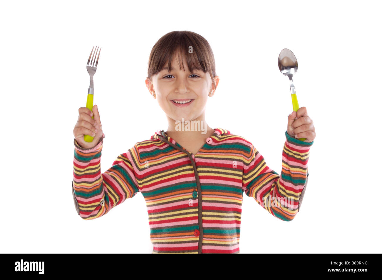 Adorable girl with fork and spoon ready to lunch on a over white