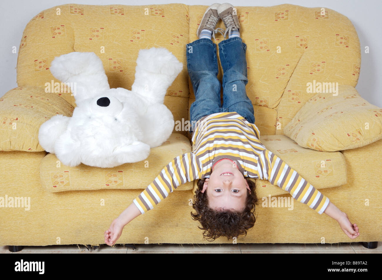 Adorable boy with teddy bear in a sofa Stock Photo - Alamy